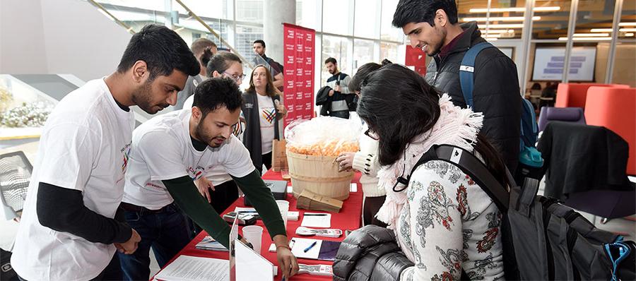 Students man a table on Giving Tuesday