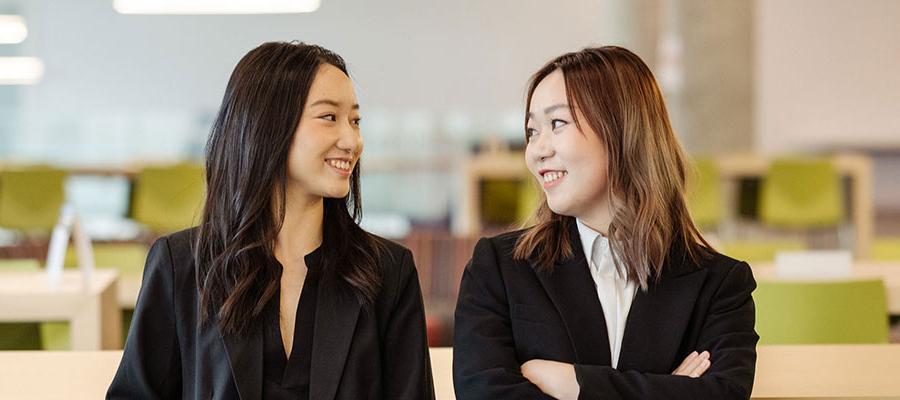 Two female MSBA students in the masters lounge