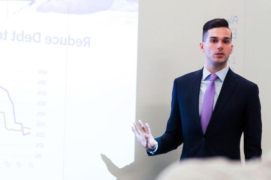 Male student presenting during management game